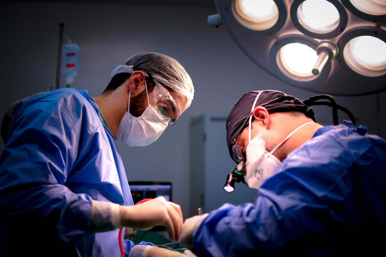 Plastic surgeons performing breast surgery in operating room