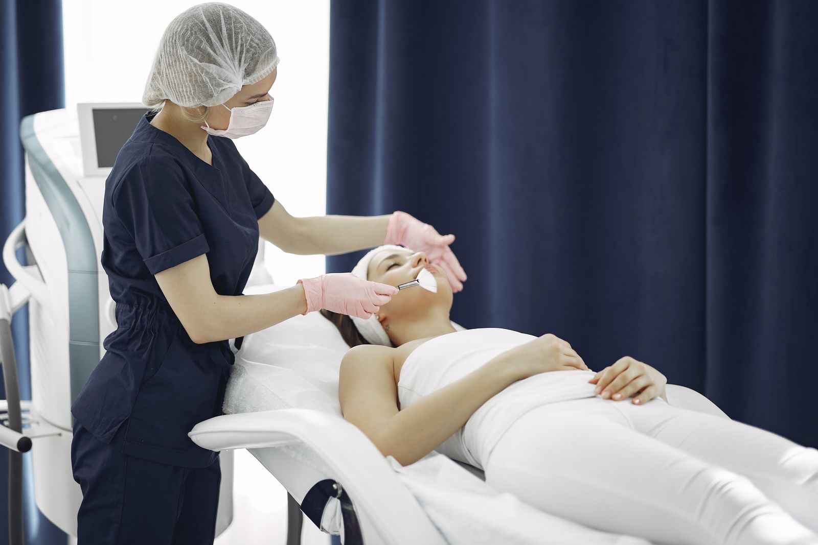 Asian woman receiving facial treatment at Dubai spa clinic
