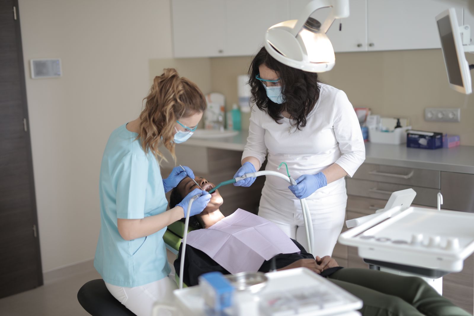 Dentists treating patient in modern dental clinic Dubai