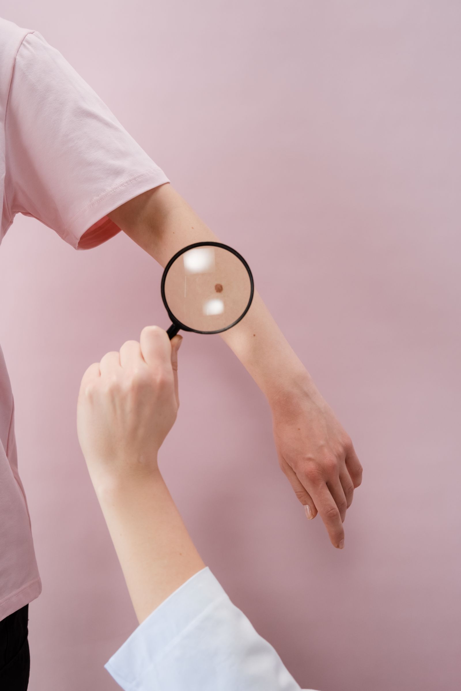 Dermatologist examining skin with magnifier Dubai