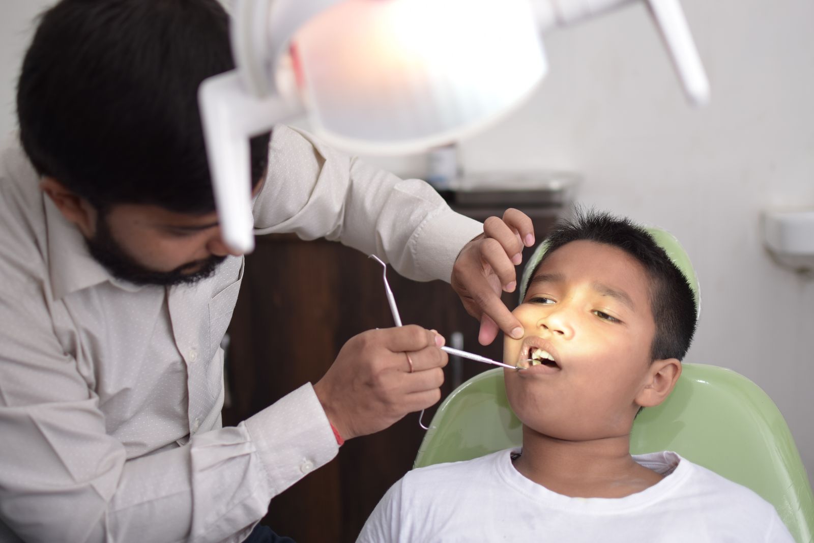Pediatric dentist checking child teeth in Dubai clinic